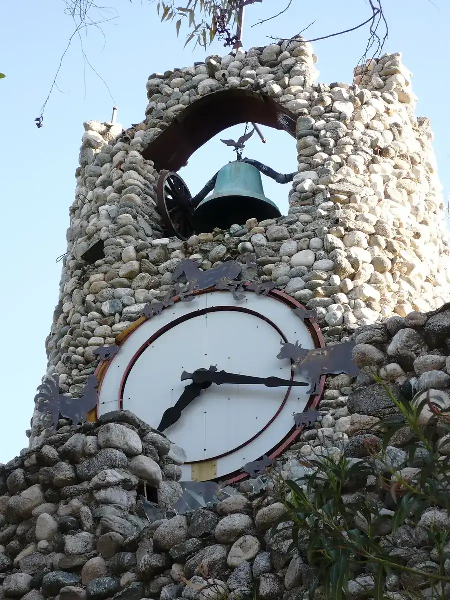 Stone and bottle clock tower at Rubel Castle in Glendora on a sunny day