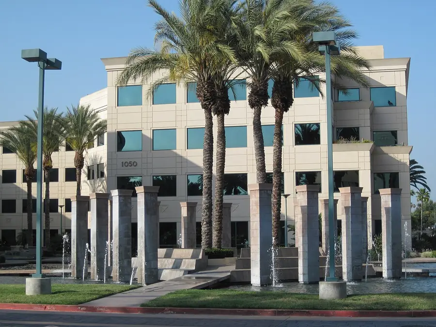 Glass office building framed by tall palm trees in West Covina