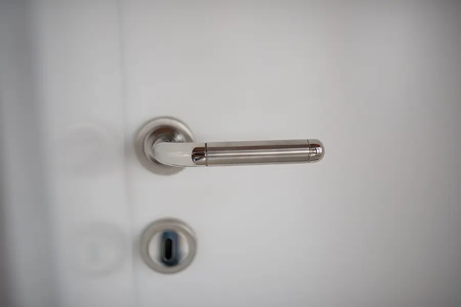 Lever door handle and keyhole on a white interior door