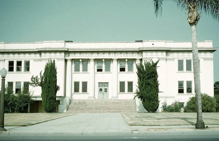 Covina Union High School building with palm trees on a clear day
