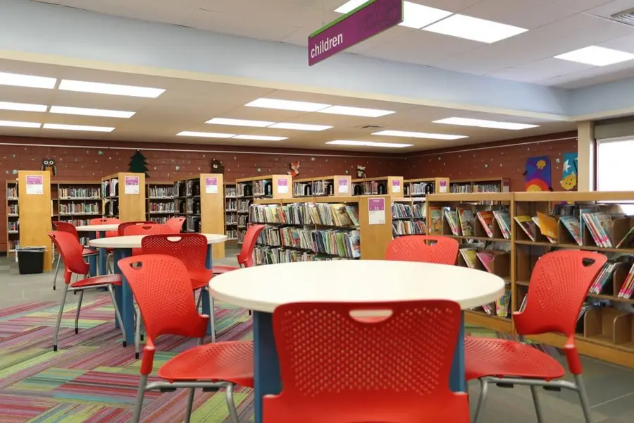 Inside the El Monte Library with red chairs and tall book shelves