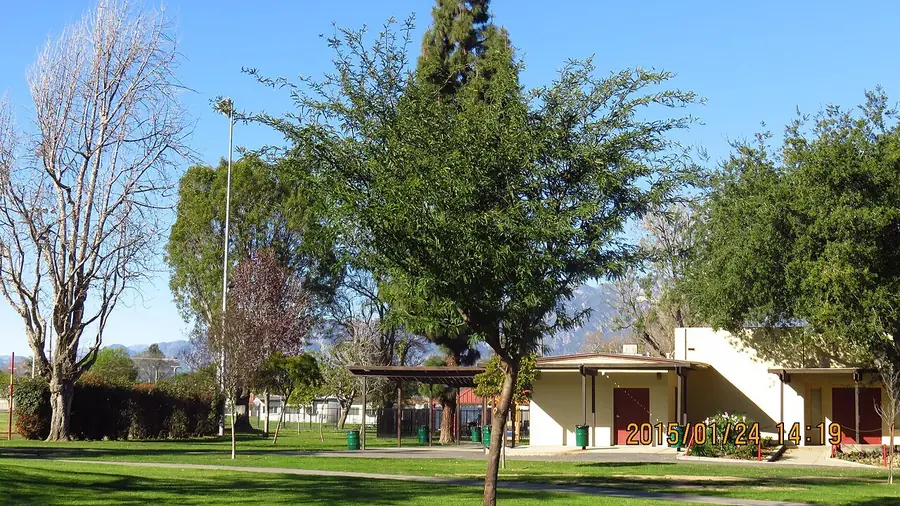Single-story house and green lawn under shade trees in Rosemead