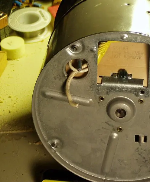 Bottom of a removed garbage disposal showing the reset button and wiring