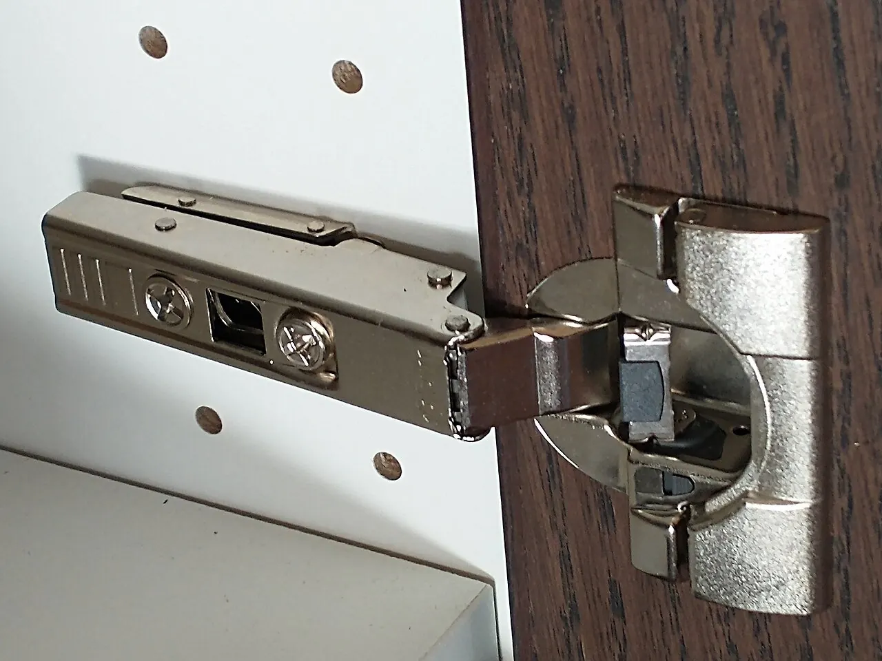 Concealed cabinet hinge with a 110 degree opening