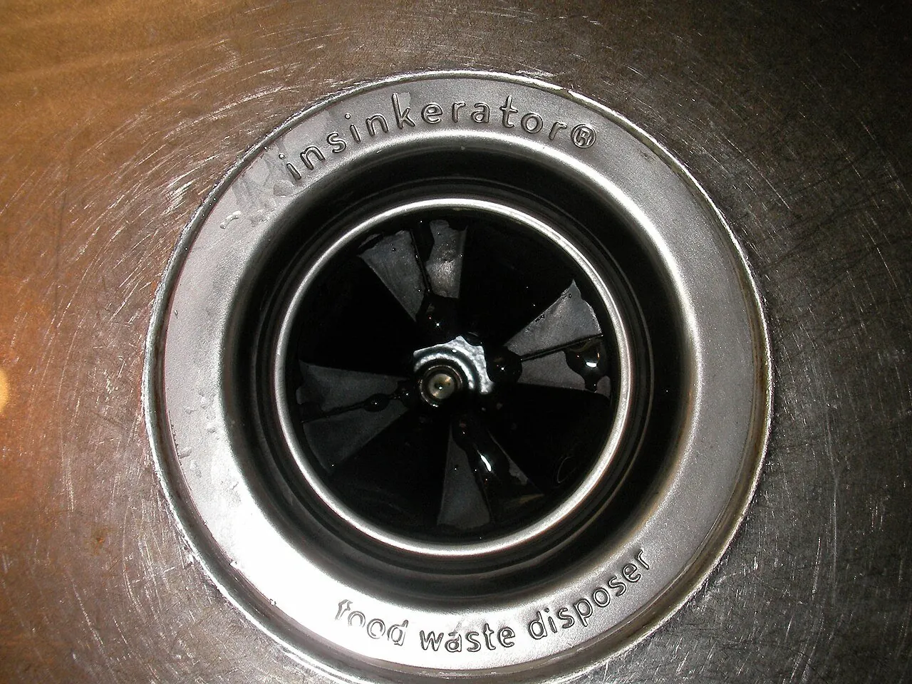 Newly installed garbage disposal under a kitchen sink