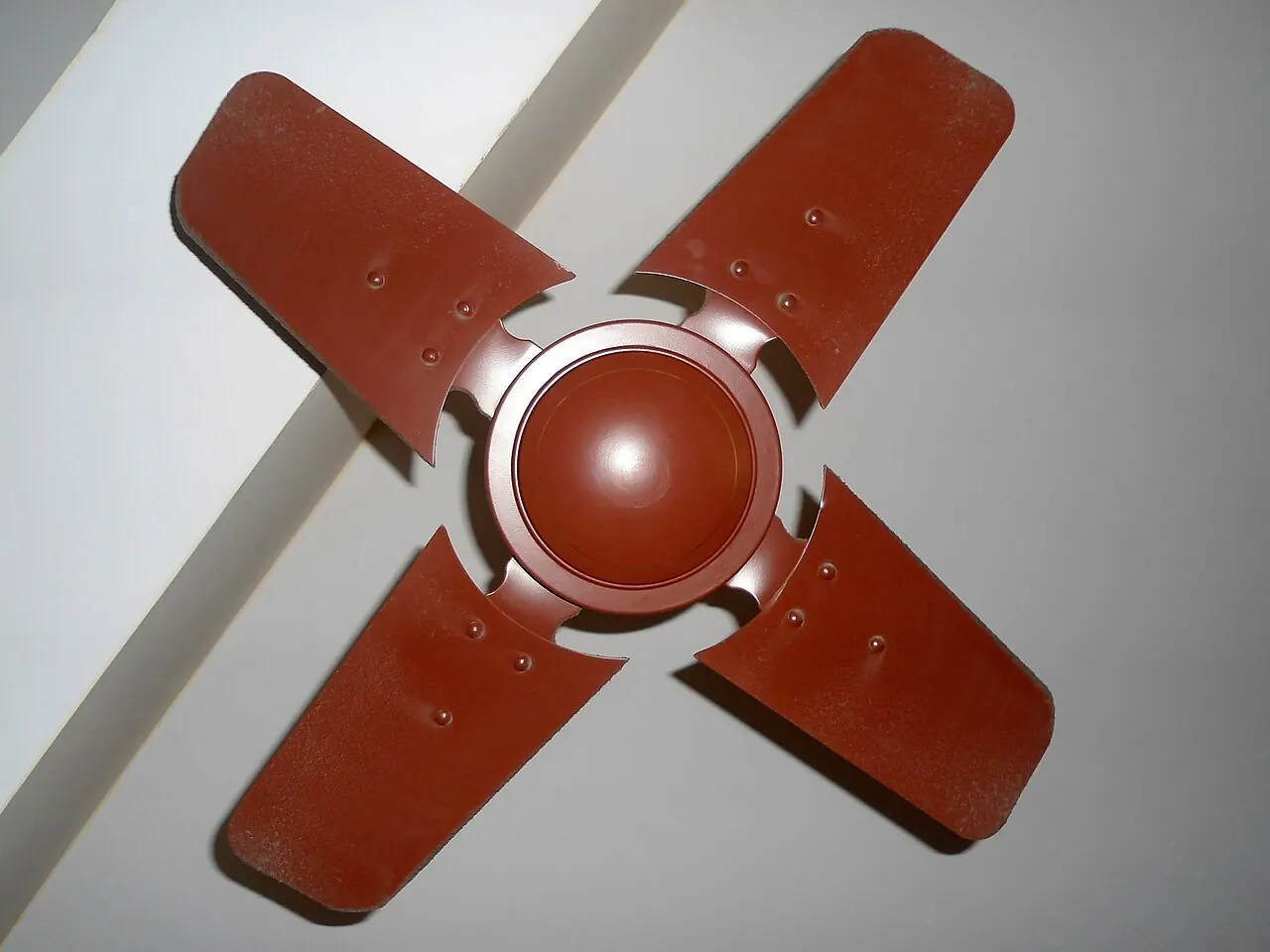 Small four-blade ceiling fan on a white ceiling