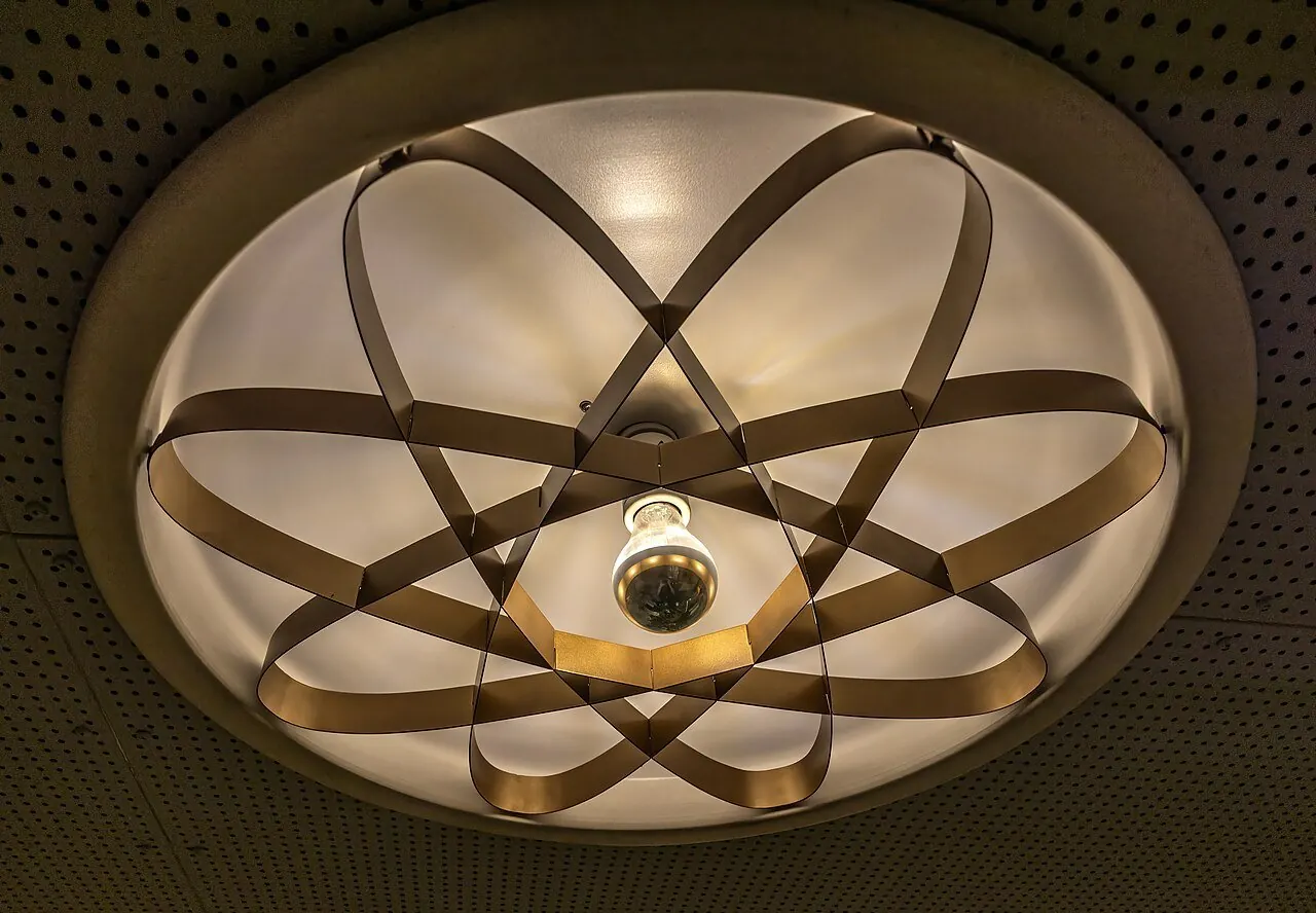 Round flush-mount ceiling light fixture with a decorative pattern
