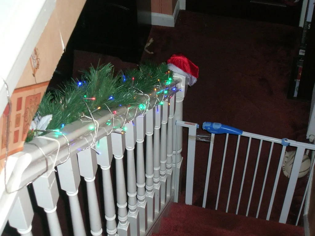 Baby gate fitted across the top of a staircase