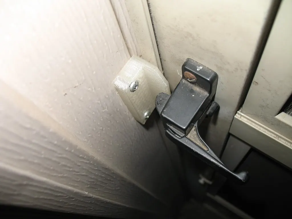 Latch installed on the edge of a screen door