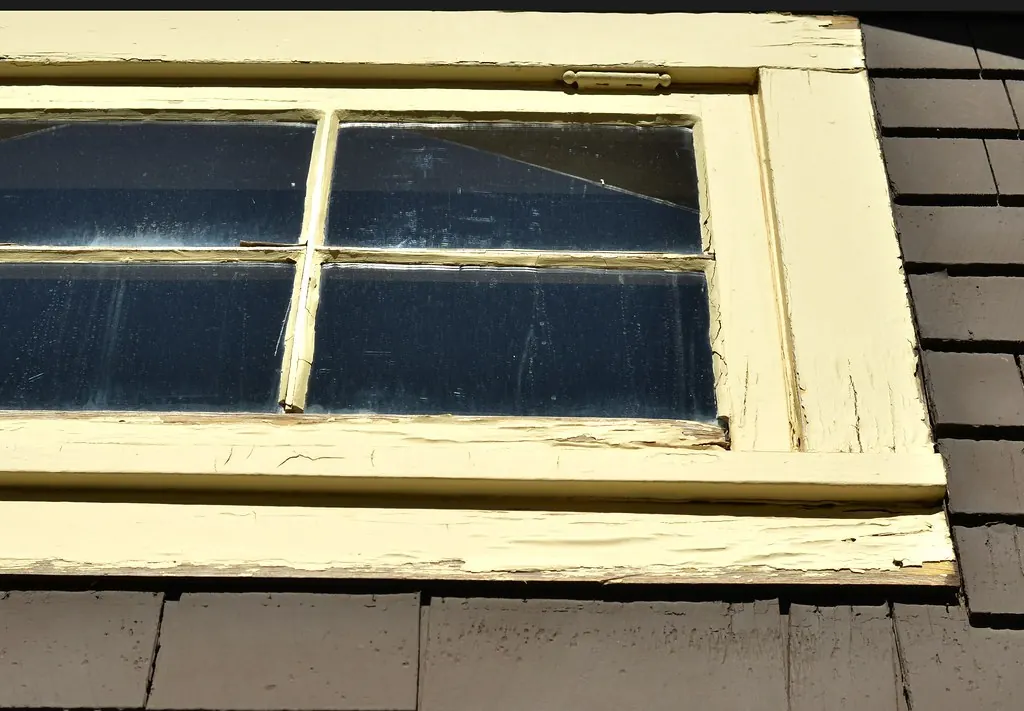 Old wooden window frame with worn paint and glazing