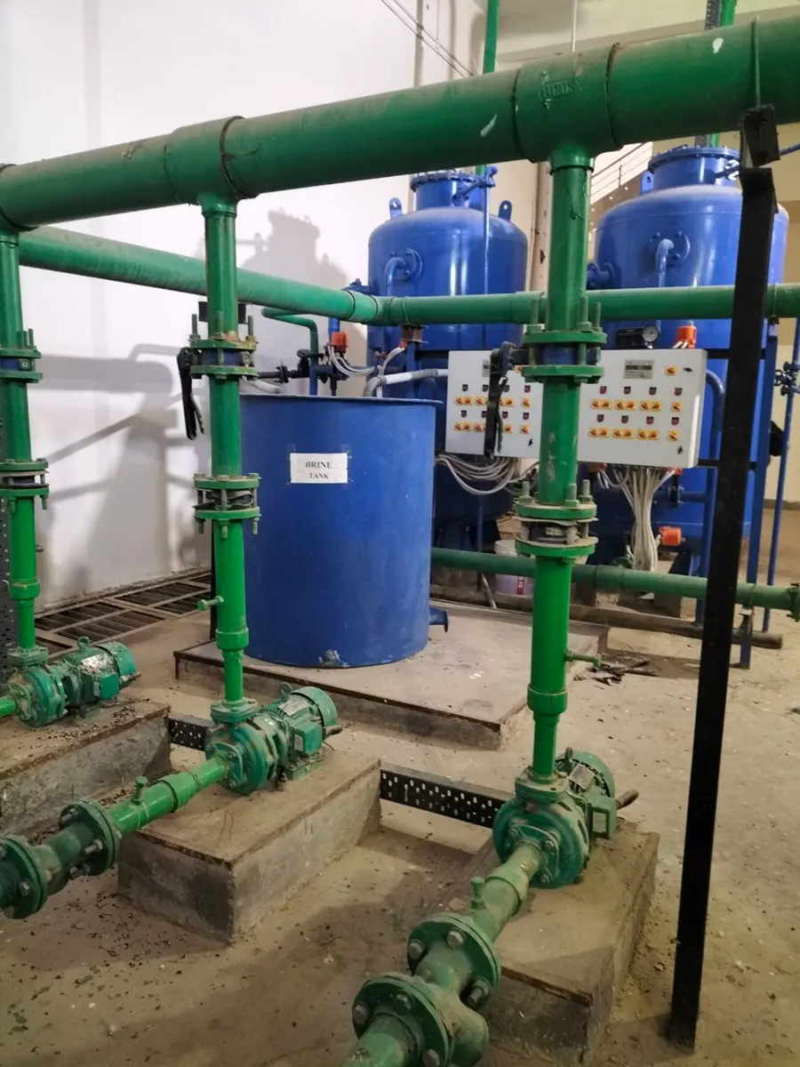 Brine tank and softening tanks connected with green piping