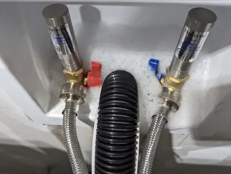 Laundry box with hot and cold washer valves and the drain hose