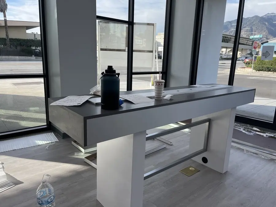 Assembled white console table with a dark top in a bright room